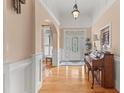 Elegant foyer with hardwood floors, wainscoting, and a grand arched entryway leading to other rooms at 2000 Silverleaf Dr, Youngsville, NC 27596