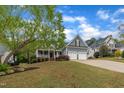 Charming home with a welcoming front porch, attached two-car garage, and well-manicured lawn at 212 Hein Dr, Clayton, NC 27527