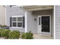 Inviting front door of the residence, complemented by a manicured garden and freshly painted column at 2214 Bayswater Dr, Creedmoor, NC 27522