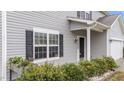 Close-up of the front entrance showcases the black door, window, and manicured landscaping at 2214 Bayswater Dr, Creedmoor, NC 27522