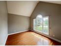 Bedroom featuring hardwood floors and a large window with natural light at 222 Creststone Dr, Cary, NC 27519
