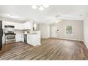 Open concept living room and kitchen featuring wood floors and stainless steel appliances at 225 Lodestone Dr, Durham, NC 27703