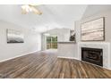 Spacious living room featuring wood floors, fireplace, and sliding doors to the outdoor patio at 225 Lodestone Dr, Durham, NC 27703
