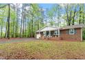 Quaint single-story home surrounded by mature trees in a serene setting at 2314 Clements Dr, Durham, NC 27704