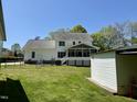 Well-maintained backyard featuring a screened-in porch, shed and grassy area at 2385 Olde Spring Ct, Graham, NC 27253