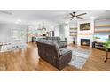 Spacious living room with hardwood floors, a cozy fireplace, and an open floor plan at 241 Indigo St, Lillington, NC 27546