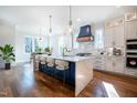 Spacious kitchen with modern appliances, a large island with seating, and white cabinetry at 3000 Eden Harbor Ct, Raleigh, NC 27613