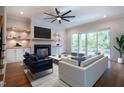 Bright living room with a black fireplace, built in shelving, and a sliding glass door to the backyard at 3000 Eden Harbor Ct, Raleigh, NC 27613