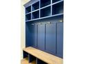 Stylish mudroom with navy blue cabinetry, gold hardware, and a built-in bench at 3000 Eden Harbor Ct, Raleigh, NC 27613
