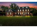 Two-story brick home with black shutters at twilight, with a manicured lawn at 3001 Greystone Dr, Rocky Mount, NC 27804