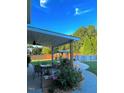 Backyard patio showcasing an outdoor dining area, flower garden, and above-ground pool for relaxation at 3098 Creek Point Rd, Graham, NC 27253