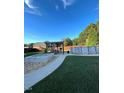 Spacious backyard highlighting an above-ground pool, outdoor seating beneath a pergola, and landscaped area at 3098 Creek Point Rd, Graham, NC 27253
