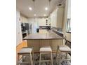 Island kitchen features granite countertops, a mosaic backsplash, and decorative lighting at 3098 Creek Point Rd, Graham, NC 27253