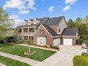 Lovely two-story brick home with a two-car garage, a basketball hoop, and a well-maintained lawn at 312 Alliance Cir, Cary, NC 27519