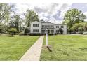 Beautiful two-story home with manicured lawn, brick walkway, black shutters, and mature landscaping at 3609 Hawthorne Rd, Rocky Mount, NC 27804