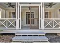 Welcoming front entrance with a screen door, ceiling fans and outdoor lighting at 39 Drayton St, Clayton, NC 27527
