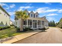 Inviting two-story home with a large, covered porch and lush green lawn at 39 Drayton St, Clayton, NC 27527