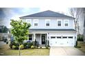 Charming two-story home with a well-manicured lawn, attached two-car garage, and inviting front porch at 408 Torwood Cir, Apex, NC 27523