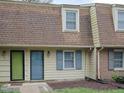 Exterior view of townhouses featuring brick accents, muted siding and shingles, and colorful front doors at 4816 Blue Bird Ct # B, Raleigh, NC 27606