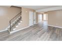 Spacious living room featuring neutral paint, hardwood floors, a staircase, and access to a sunroom at 4816 Blue Bird Ct # B, Raleigh, NC 27606