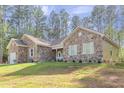 Charming stone-clad home with a well-maintained lawn and appealing architectural details at 490 Shawnee Dr, Louisburg, NC 27549