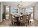 Formal dining room with a wooden table, seating for six, and natural light from large windows at 50 Gadwall Ct, Zebulon, NC 27597