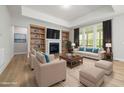 Inviting living room with a fireplace, built-in bookshelves, and comfortable seating arrangement at 50 Gadwall Ct, Zebulon, NC 27597
