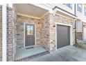 Home exterior featuring stone veneer, a gray door, and an attached one car garage at 518 Retreat Ln, Wake Forest, NC 27587
