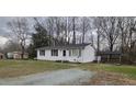 Charming one-story home with white siding, a dark roof, and a well-maintained front yard on a cloudy day at 530 Broad Rd, Roxboro, NC 27573