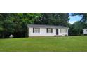 Single story house featuring a lush green lawn and a classic white exterior, surrounded by mature trees at 530 Broad Rd, Roxboro, NC 27573