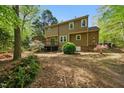 Private backyard with mature trees, a small deck, and plenty of space for outdoor activities at 5610 Frenchmans Creek Dr, Durham, NC 27713