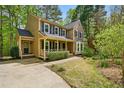 View of the exterior showcasing the home's architectural style, and yard at 5610 Frenchmans Creek Dr, Durham, NC 27713