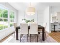 Dining room features a large window, contemporary light fixture, and a stylish dining set at 5712 Wintergreen Dr, Raleigh, NC 27609