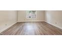 Bright bedroom with a large window and neutral walls, offering a calming space at 5804 Falls Of Neuse Rd # E, Raleigh, NC 27609
