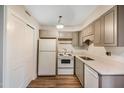 Compact kitchen with updated countertops, white appliances, and ample storage at 5804 Falls Of Neuse Rd # E, Raleigh, NC 27609