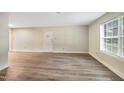The living room with new laminate floors and natural light is inviting at 5804 Falls Of Neuse Rd # E, Raleigh, NC 27609