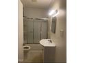 Functional bathroom featuring a shower-tub combo and sleek vanity at 610 W Old Rd, Lillington, NC 27546