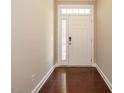 Inviting entryway featuring hardwood floors and a white door with glass accents at 65 N Wilders Ridge Way, Clayton, NC 27527