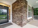 Close-up of the stone accent around the front porch, showcasing detailed craftsmanship at 65 N Wilders Ridge Way, Clayton, NC 27527