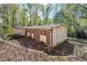 Single-story home featuring brick and wood accents, nestled in a lush, green setting for a peaceful ambiance at 6709 Johnsdale Rd, Raleigh, NC 27615