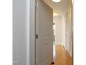 Hallway with hardwood floors and neutral wall colors leading into living space at 700 Finsbury St # 306, Durham, NC 27703