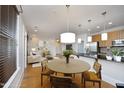 Open-concept living space showcasing a modern kitchen and a sunlit living room at 700 Finsbury St # 306, Durham, NC 27703