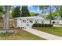 Quaint single-story home showcasing a pink front door, manicured bushes, and a neatly paved walkway to the entrance at 703 E Horne St, Clayton, NC 27520