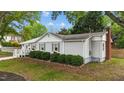 Side view of a well-maintained single-story house with landscaped bushes and a fenced yard at 703 E Horne St, Clayton, NC 27520