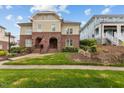 Charming exterior elevation with brick facade, arched entryway, green lawn, and inviting curb appeal at 714 Mordecai Towne Pl, Raleigh, NC 27604