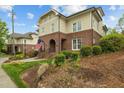 Inviting exterior of a home with a brick facade, arched entryway, and well-manicured landscaping at 714 Mordecai Towne Pl, Raleigh, NC 27604