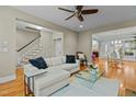Bright living room featuring hardwood floors, staircase, large sectional sofa and open layout at 714 Mordecai Towne Pl, Raleigh, NC 27604
