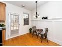 Bright breakfast nook with wood floors, a charming table set, and natural light at 746 Wickham Ridge Rd, Apex, NC 27539
