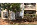 View of condominium exterior with windows, a balcony, and mature tree in the yard at 811 New Kent Pl # 1A, Cary, NC 27511