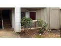 Exterior of condo with ground floor entrance, stairs to upper units, and sparse landscaping at 811 New Kent Pl # 1A, Cary, NC 27511